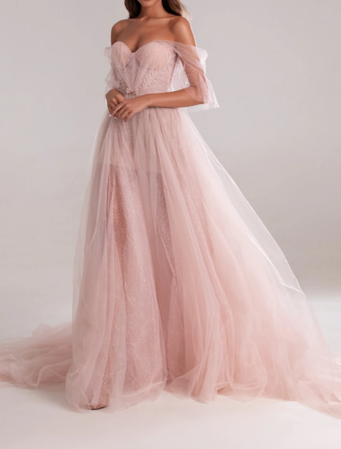 Close-up of the sweetheart neckline and delicate bow detail on the tulle gown.