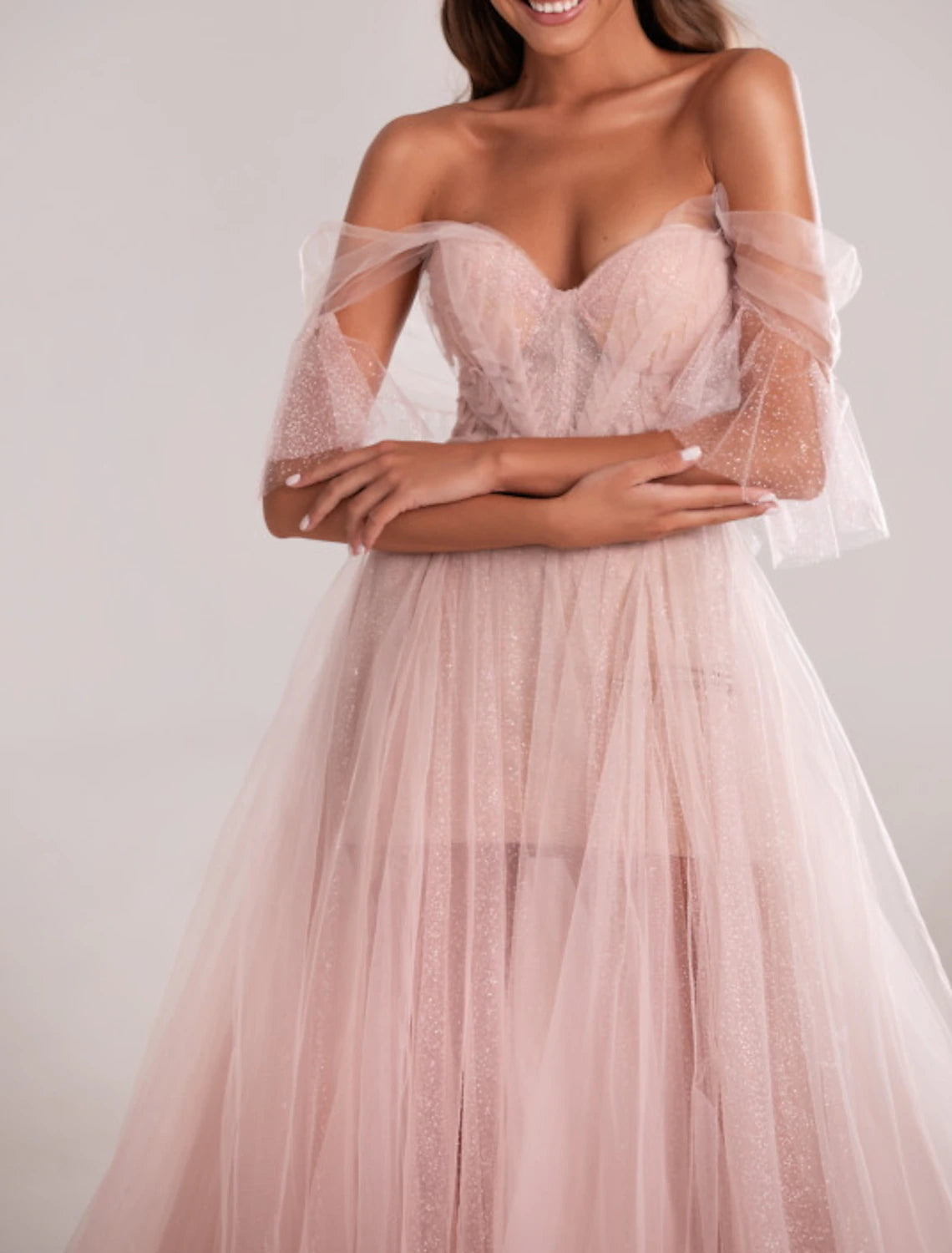 Back view of the pleated A-line evening dress, showcasing the court train.