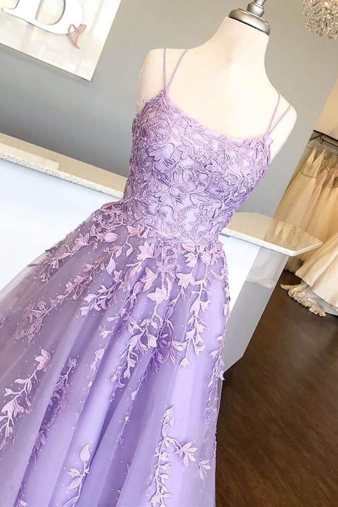 Close-up of the intricate lace appliques on the tulle fabric of the prom dress.