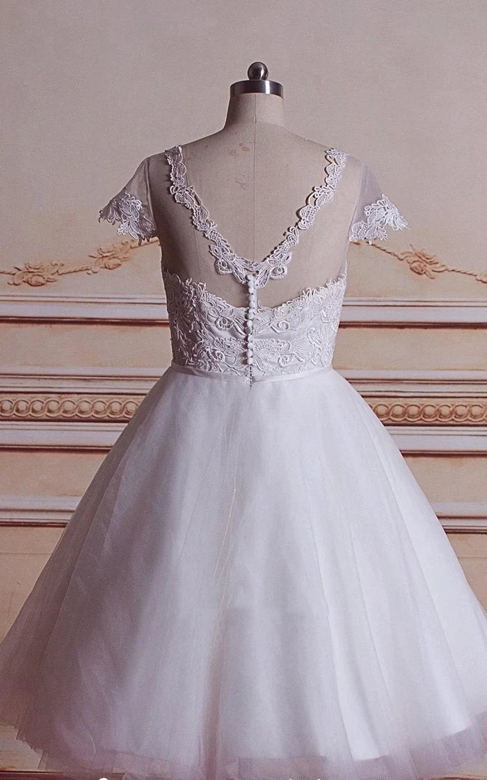 Close-up of the lace bodice and sweetheart neckline of the wedding dress.