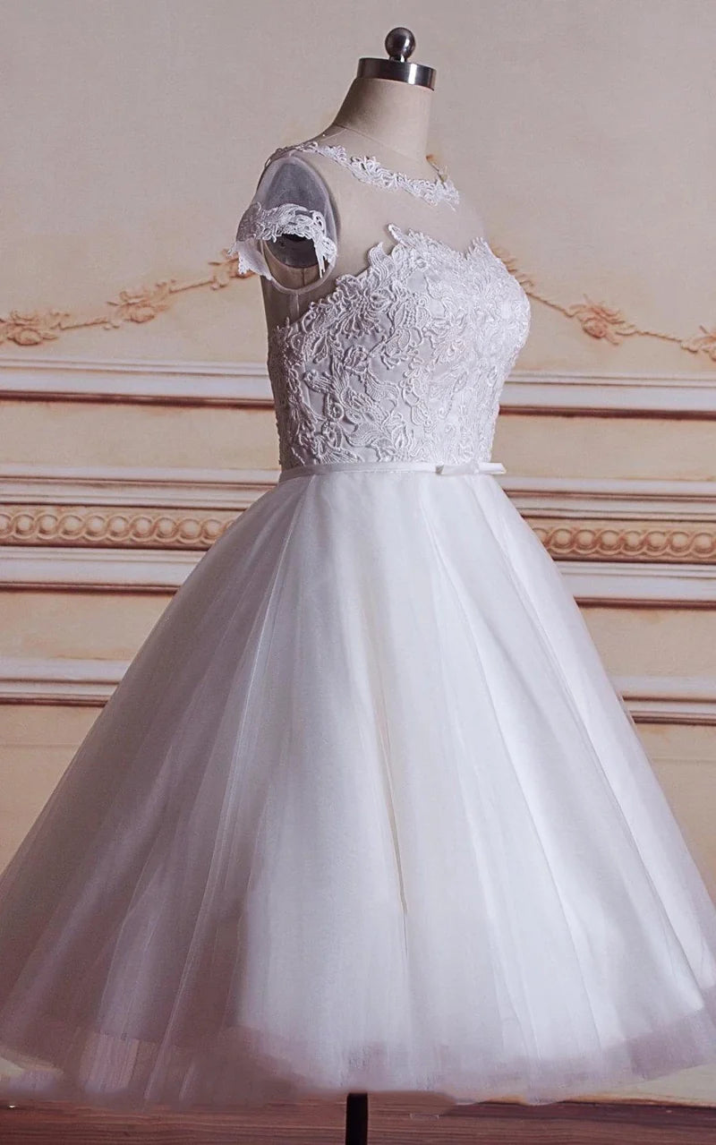 Back view of the tea-length wedding dress with flowing satin skirt.