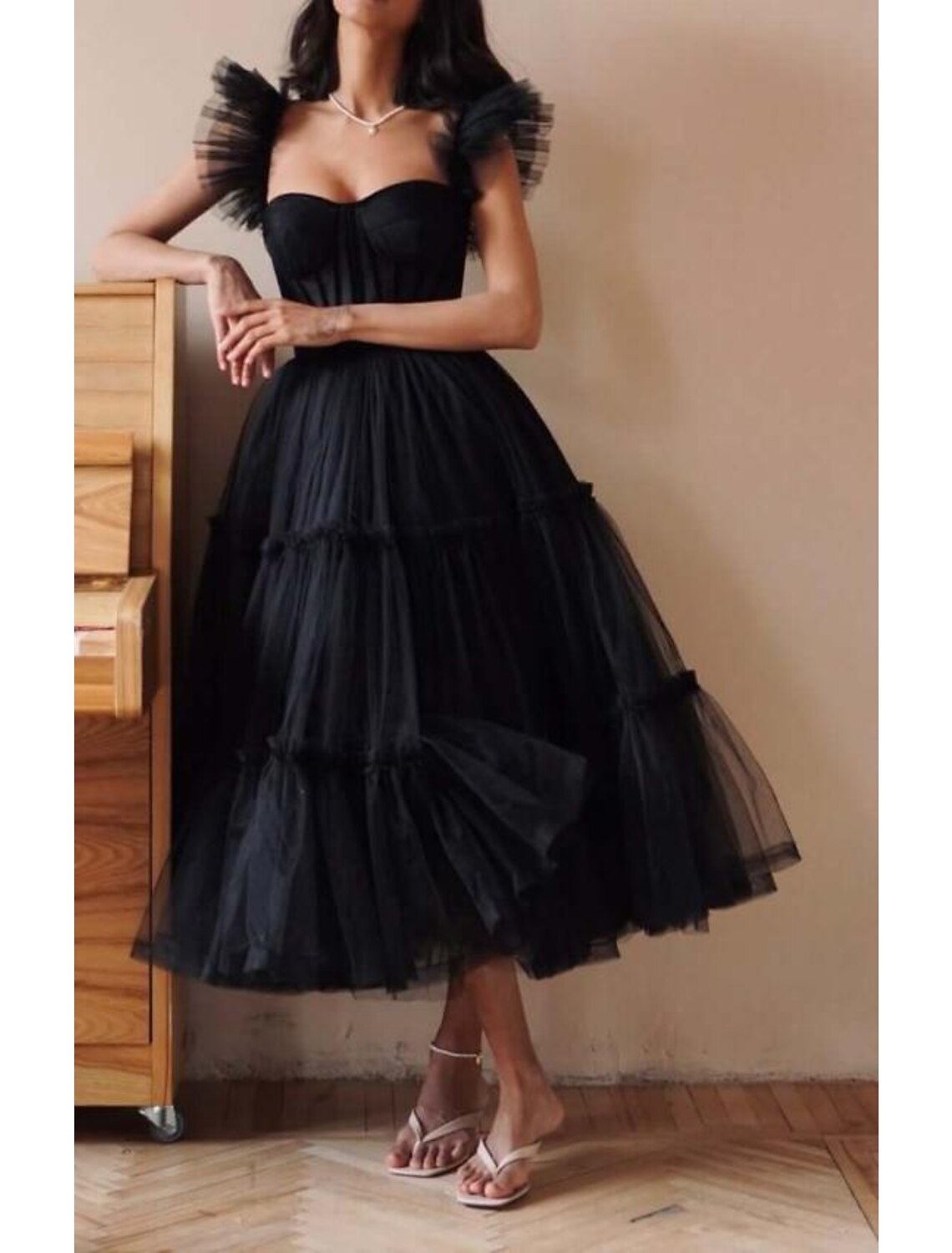 Close-up of the sweetheart neckline and tulle fabric on a gothic prom dress.