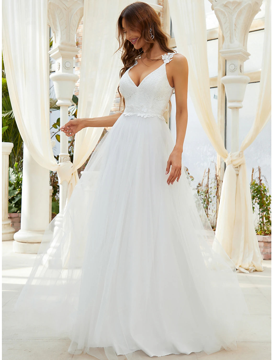 Elegant A-Line sweetheart tulle wedding dress with crystal appliques and sweep train.