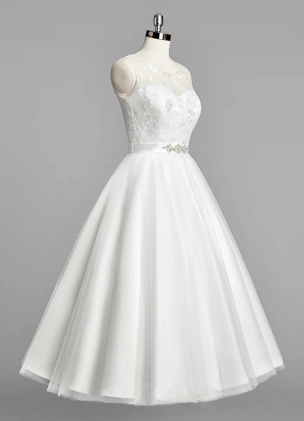 A-line tulle tea-length wedding dress with sweetheart neckline and beaded sash.