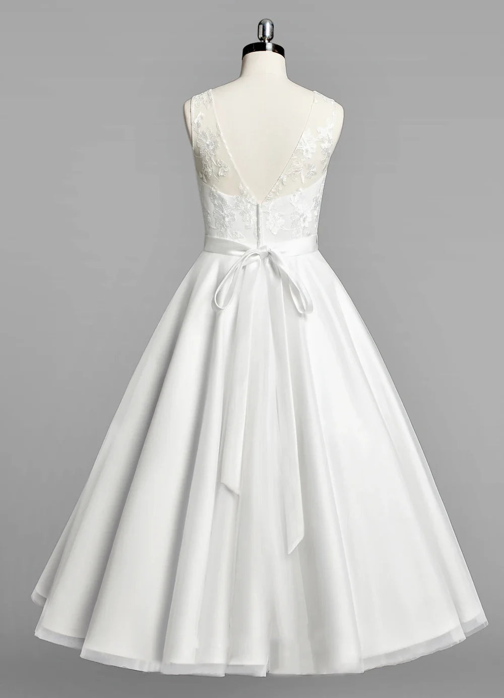 Back view of A-line tulle tea-length wedding dress with beaded sash.