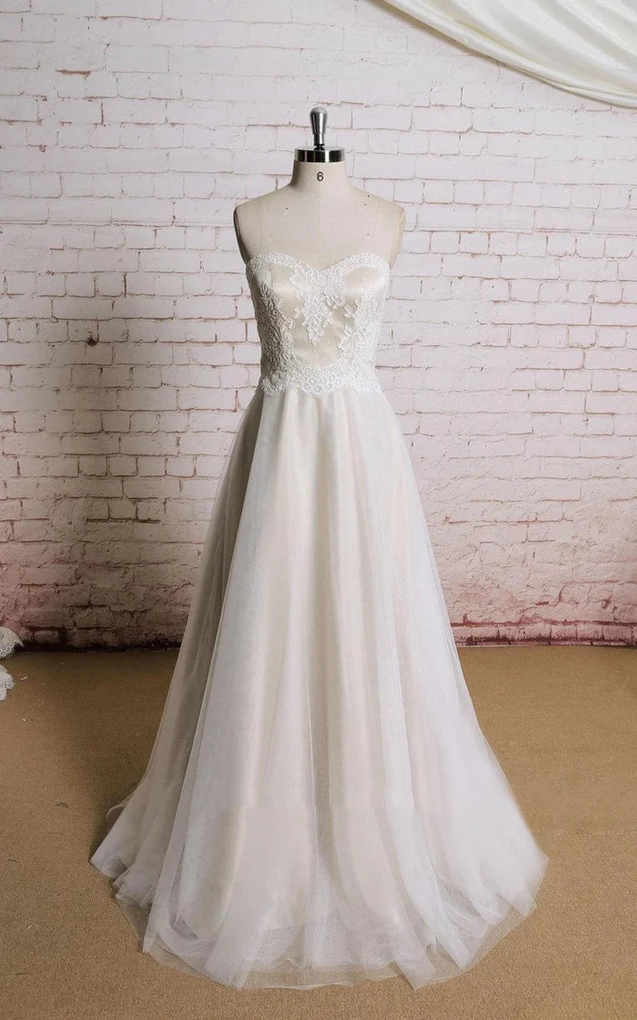 Elegant A-line tulle wedding dress with champagne underlay.