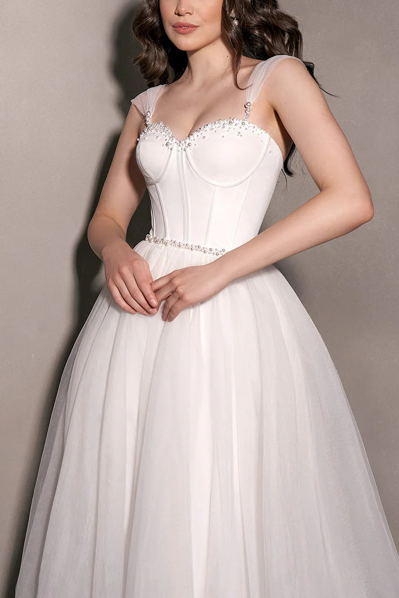 Close-up of the sweetheart neckline on the tulle wedding dress.