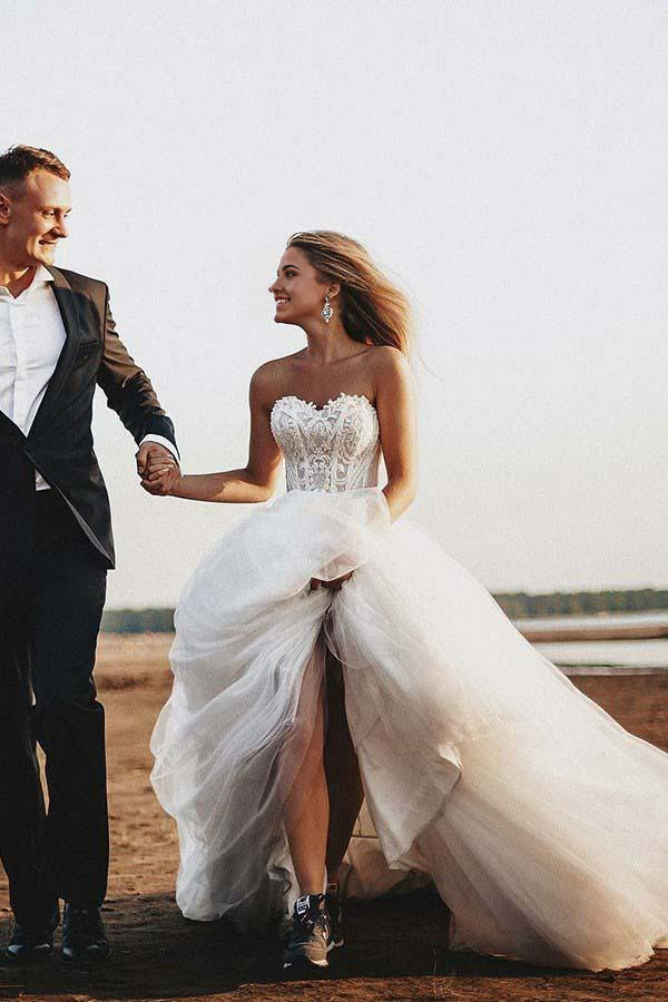 A-line sweetheart tulle wedding dress with intricate appliques and court train.