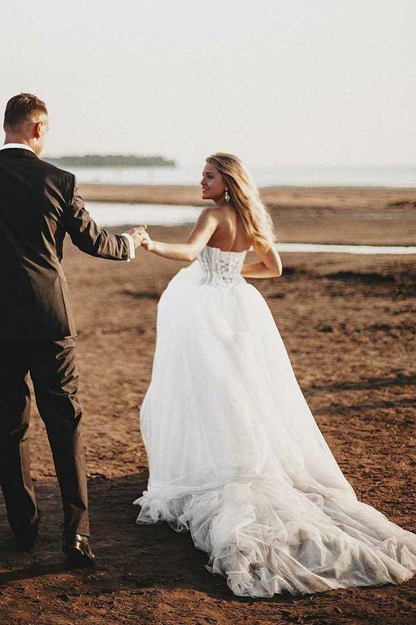 A-line sweetheart tulle wedding dress with intricate appliques and court train.