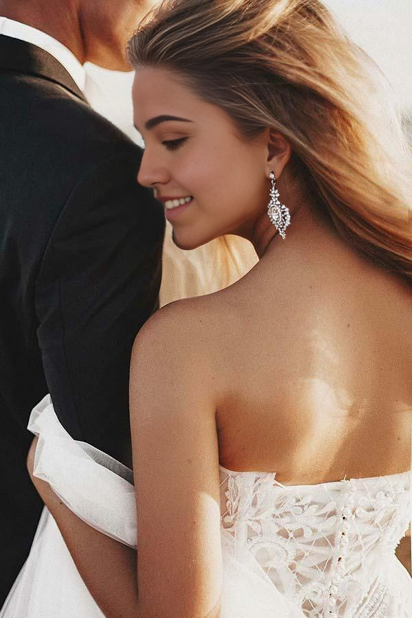 A-line sweetheart tulle wedding dress with intricate appliques and court train.