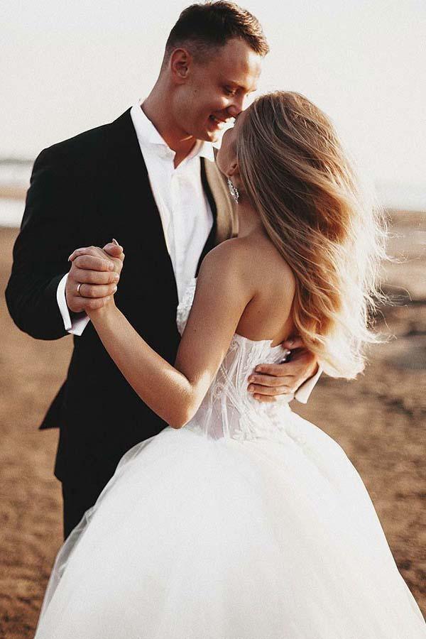 A-line sweetheart tulle wedding dress with intricate appliques and court train.
