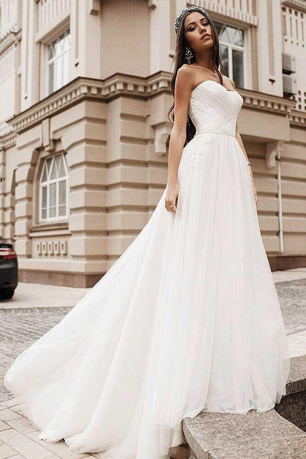 Elegant A-line sweetheart tulle wedding dress with appliques and sweep train, front view.