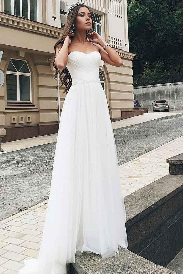 Back view of A-line sweetheart wedding dress showing sweep train and appliques.