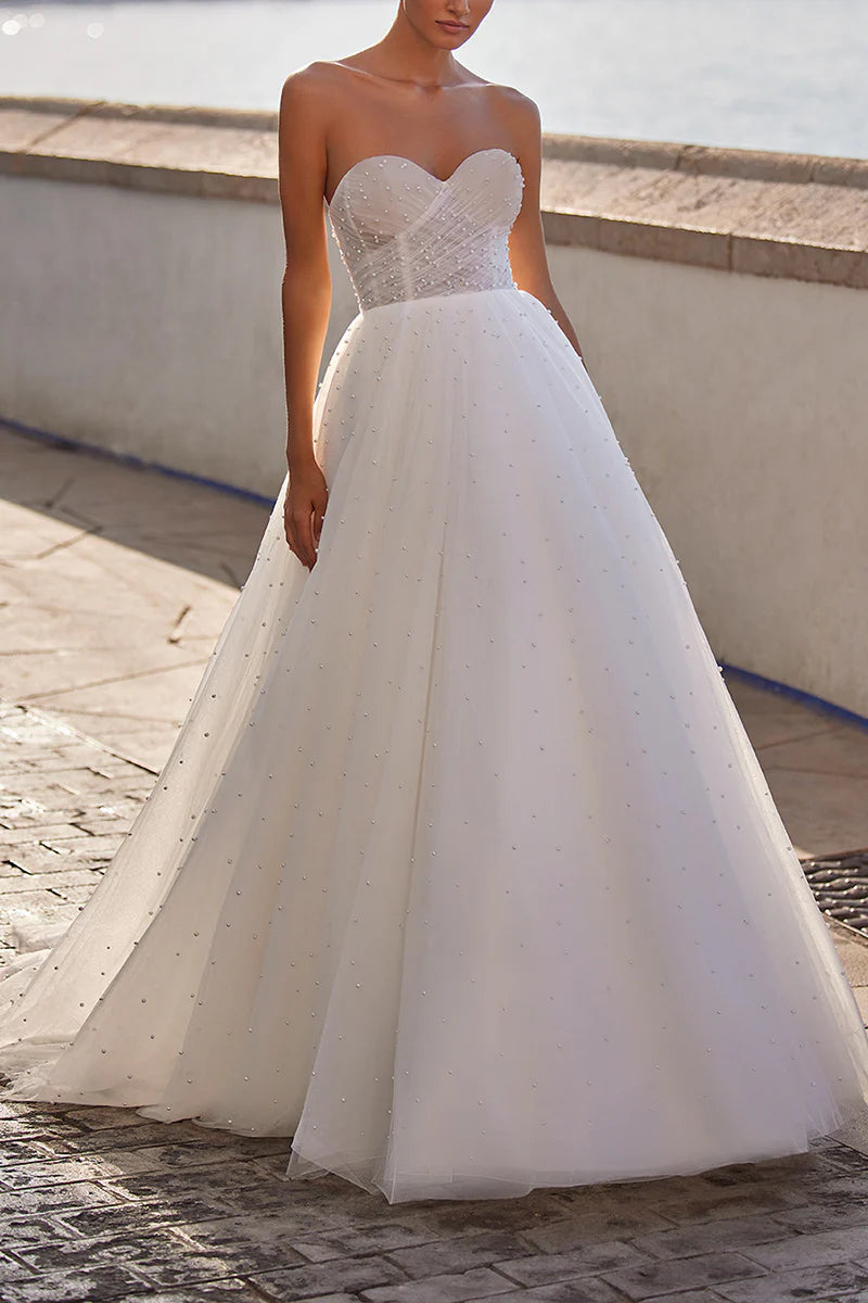 Front view of an elegant A-line sweetheart tulle wedding dress adorned with pearls.