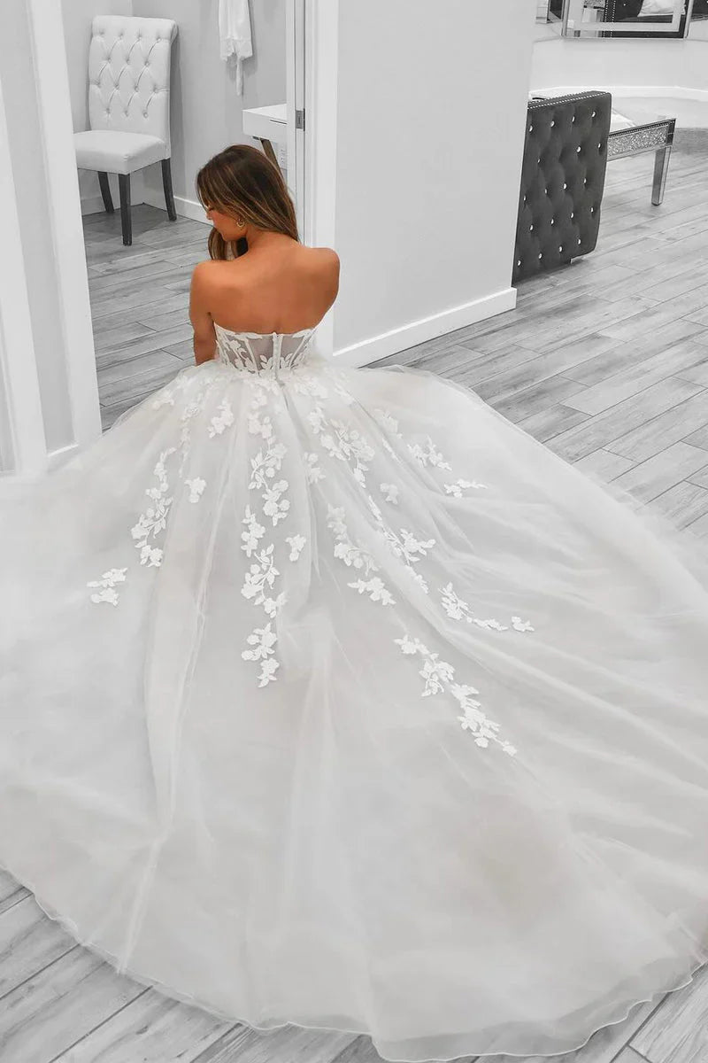 Back view of an A-line sweetheart tulle wedding dress, featuring a flowing skirt.