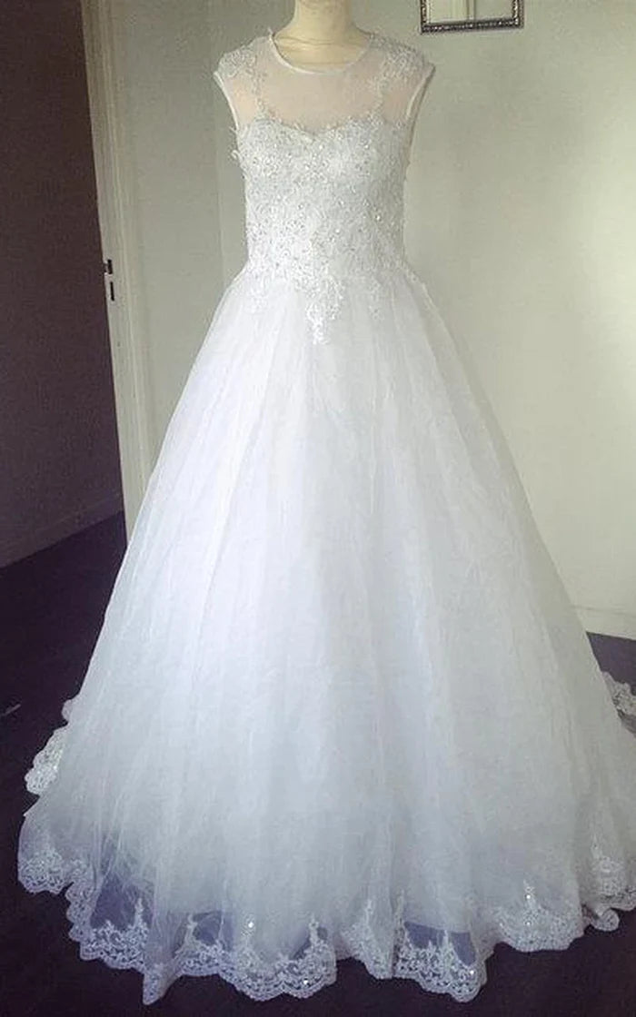 Elegant A-Line tulle wedding dress with sweetheart neckline and lace hem.