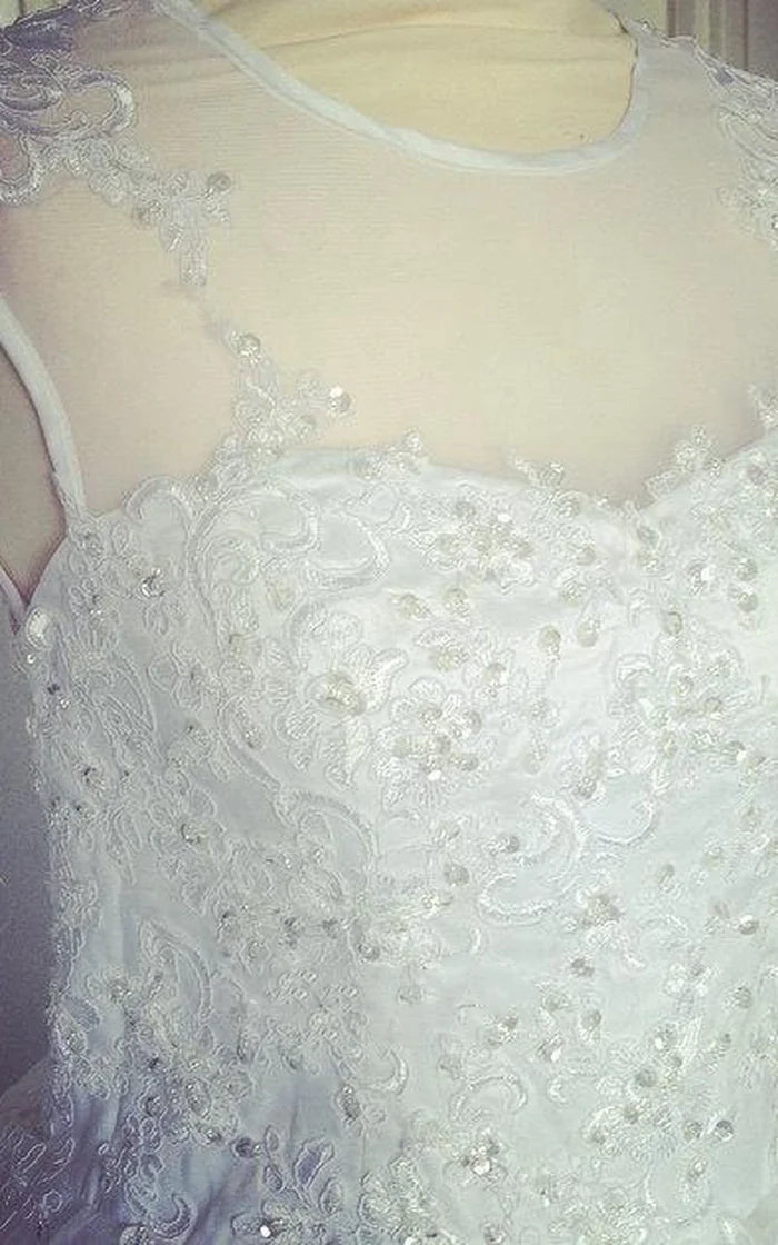 Side view of a romantic A-Line tulle bridal gown with delicate lace details.