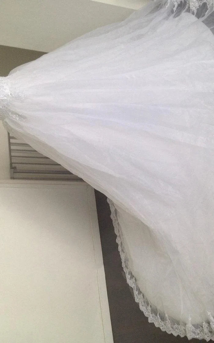 Back view of the flowy A-Line wedding dress, showcasing the tulle skirt and lace hem.