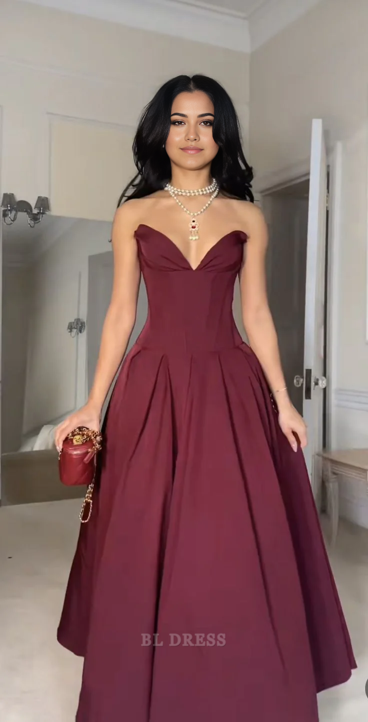 Woman wearing a burgundy A-line sweetheart V-neck formal gown.