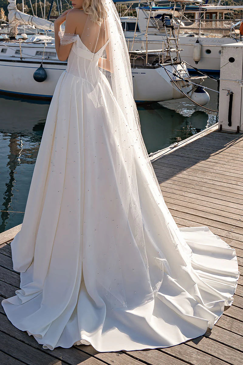 Model showcasing the back of an A-line sweetheart bridal gown.