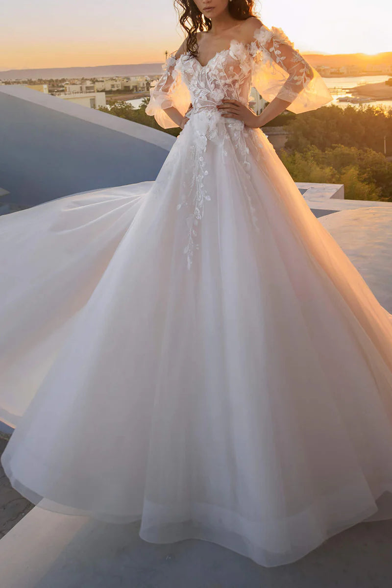 Full view of an elegant A-line wedding dress with a sweetheart neckline and long sleeves, adorned with 3D lace appliques.