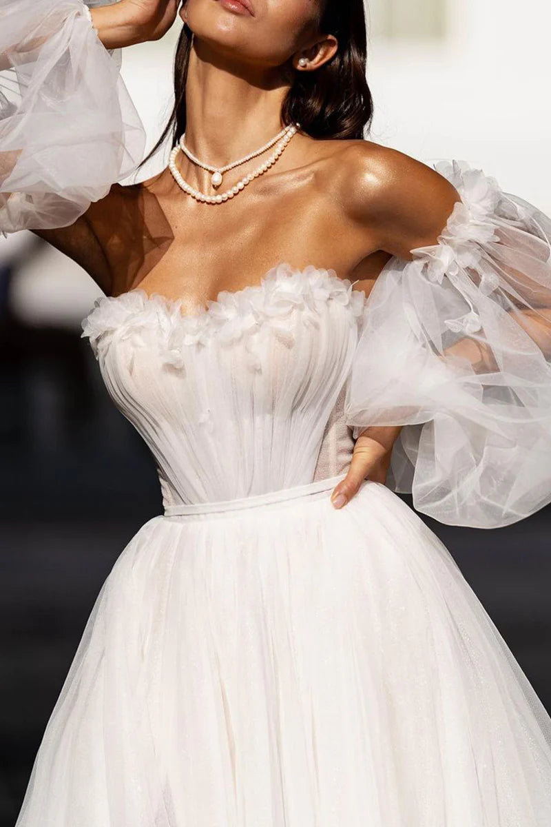 Elegant A-line wedding dress with sweetheart neckline, sleeves, and appliques.