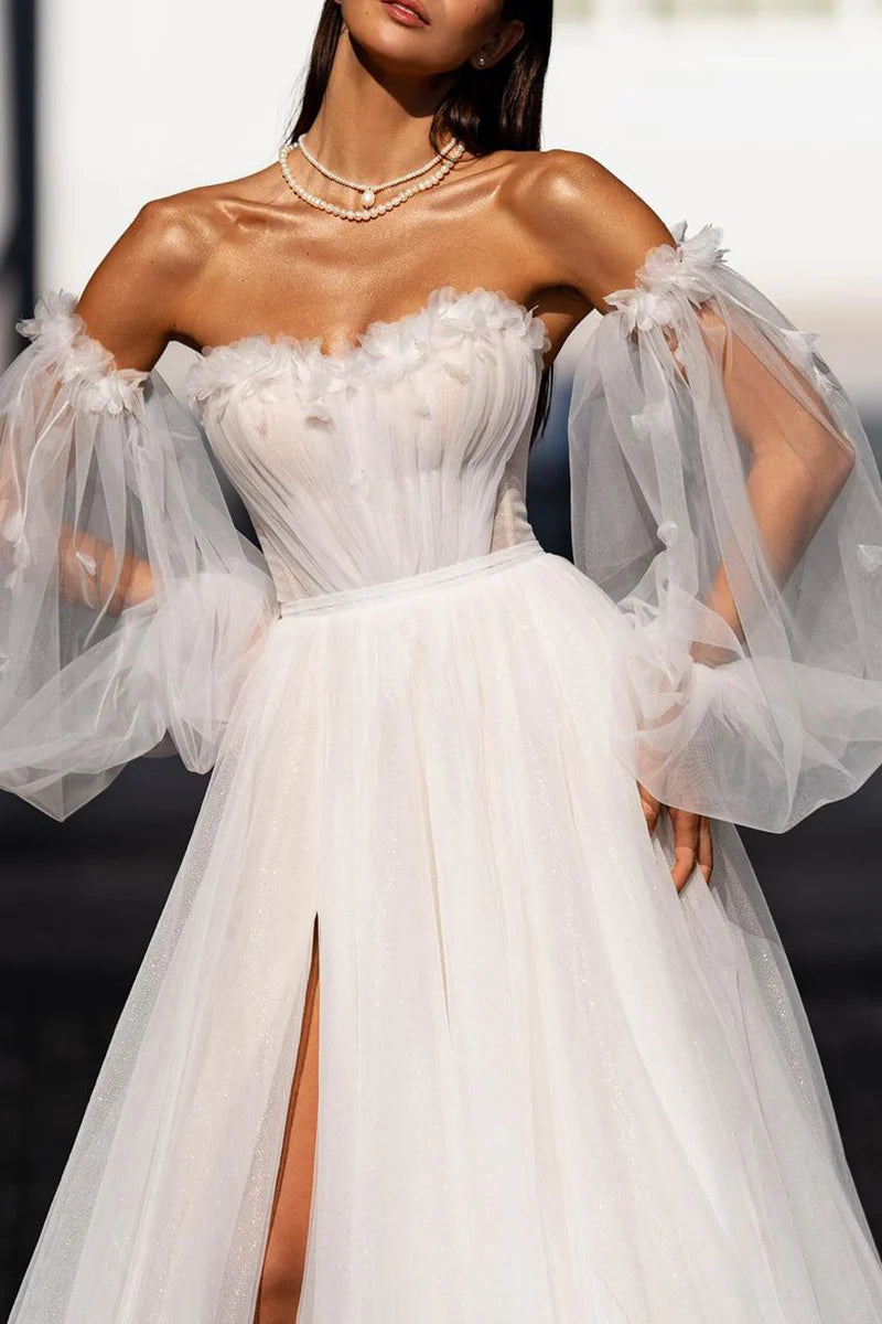 Close-up of sweetheart neckline and delicate sleeves on bridal dress.