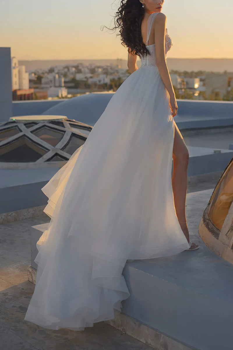 Side view of an A-line bridal gown featuring a sweetheart neckline and pearl embellishments.