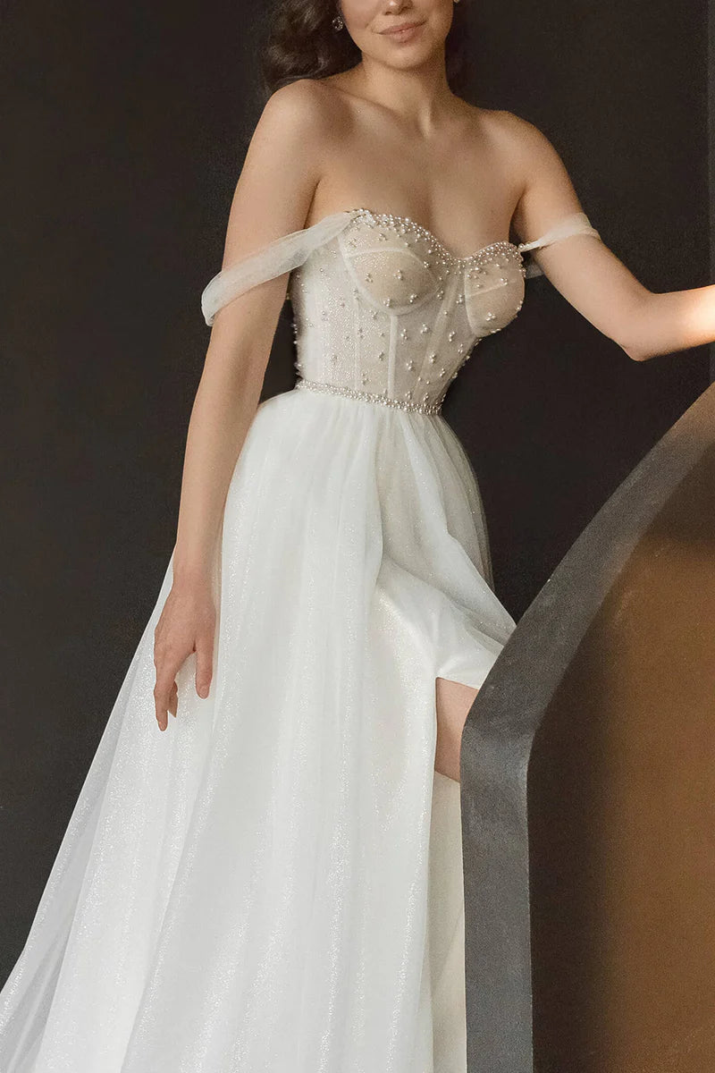 Back view of the sleeveless A-line wedding dress with pearl accents.