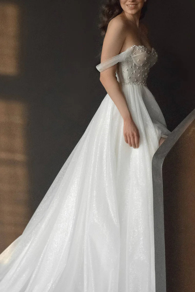 Detailed shot of the pearl embellishments on the elegant A-line bridal gown.