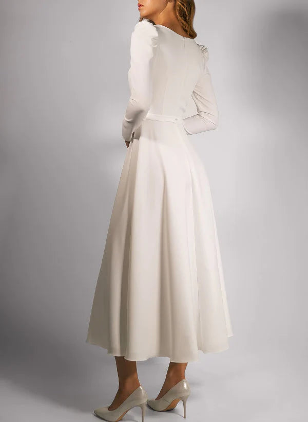Back view of an A-line tea-length wedding dress with a square neckline.