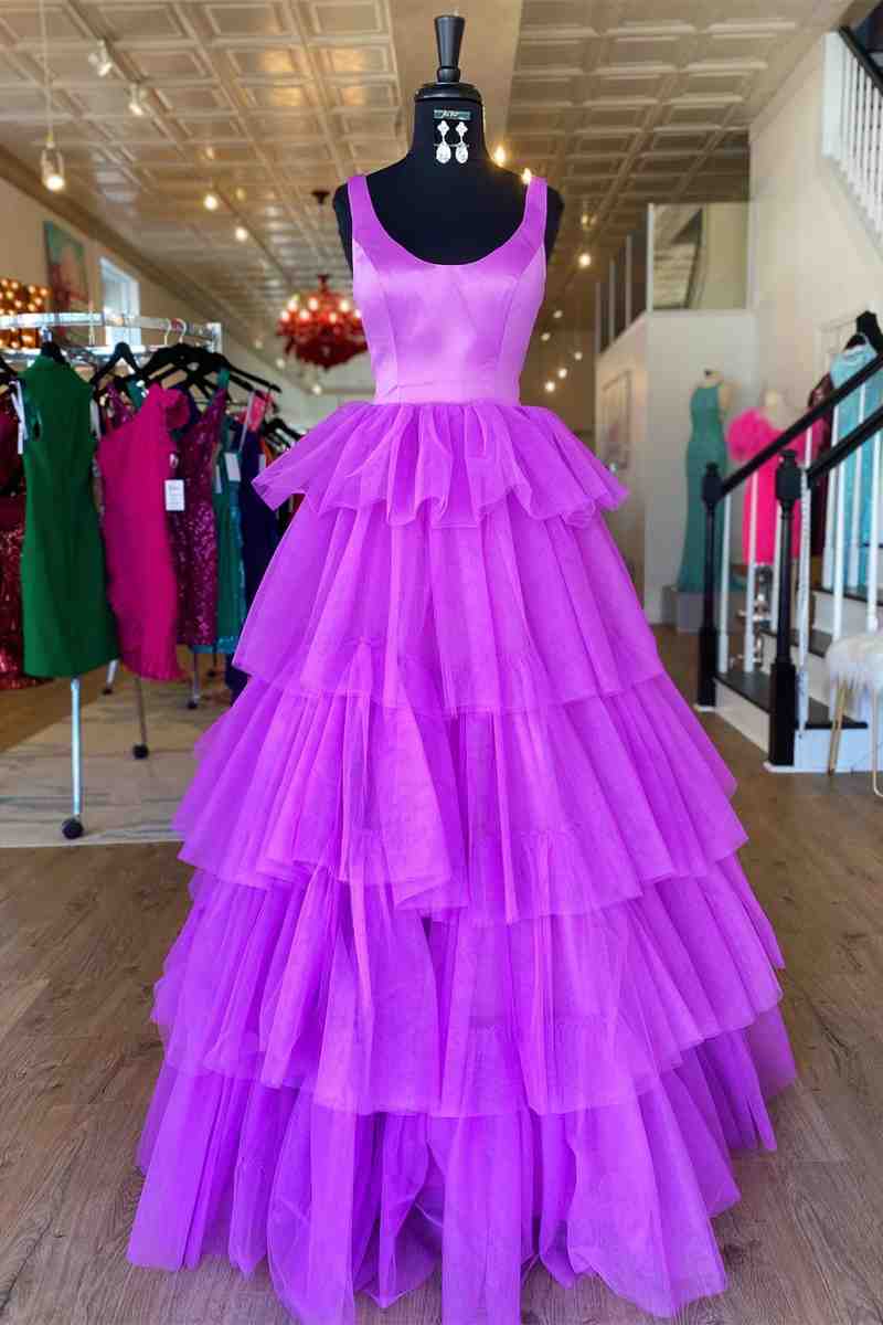 Model wearing an elegant A-line tiered tulle long prom dress with a crew neck, front view.