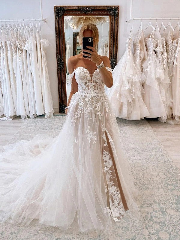 Elegant A-Line wedding dress with tulle applique, off-the-shoulder neckline, and chapel train.