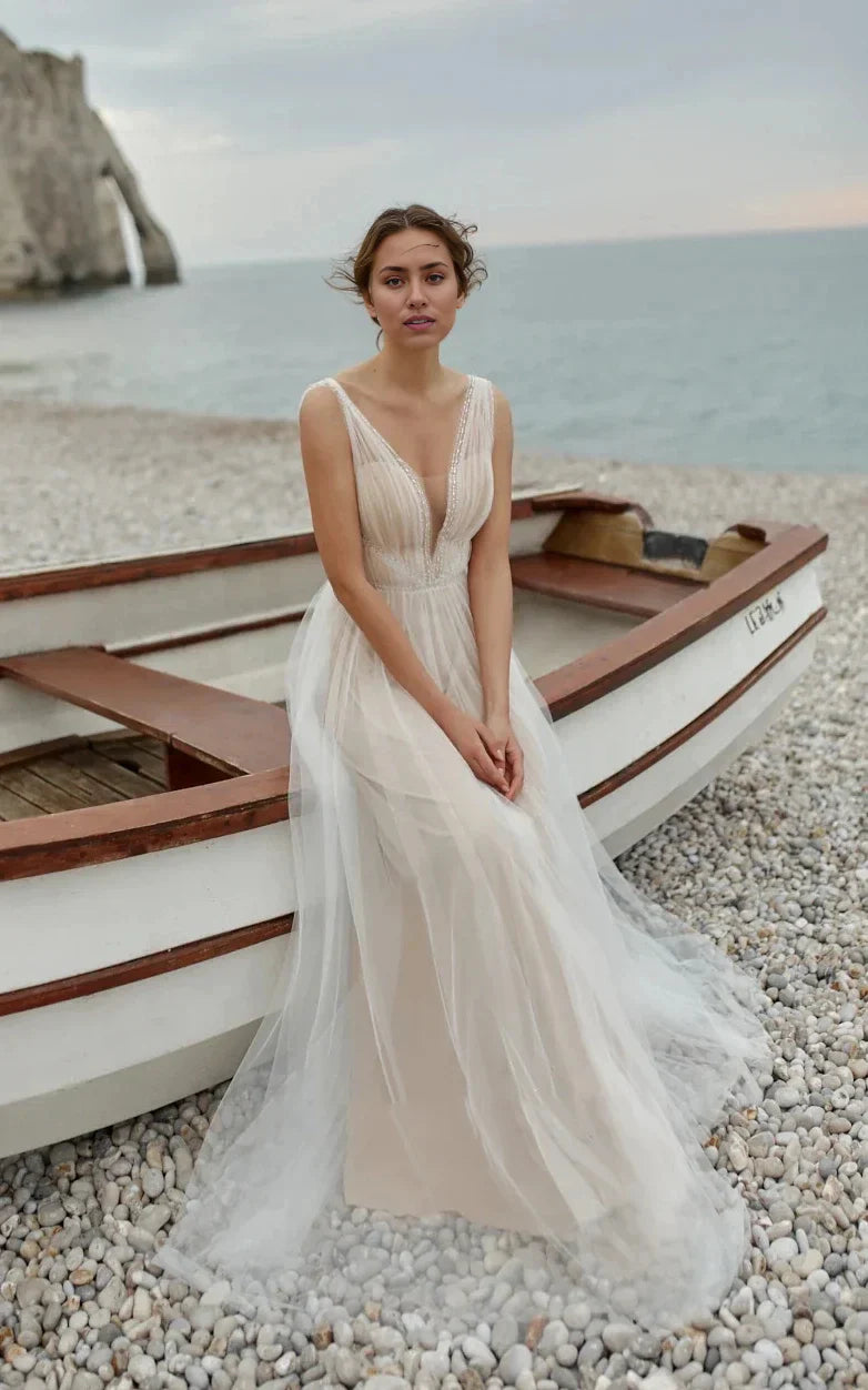 Elegant A-line tulle wedding gown with deep V-neck and sequin details.