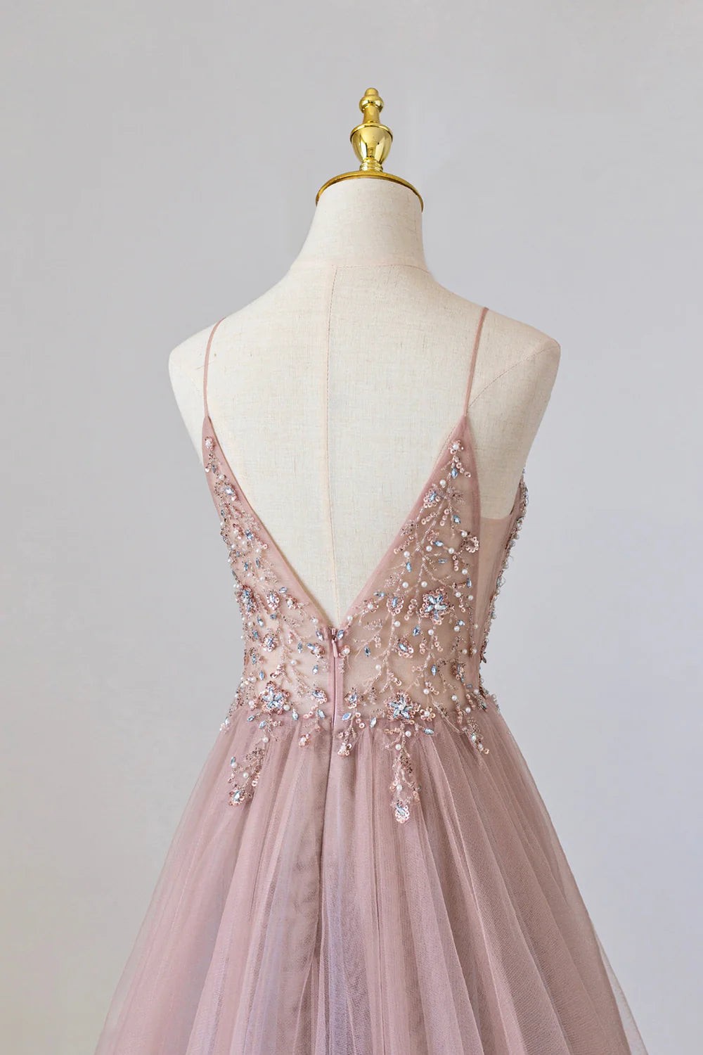Full length view of an A-line tulle long formal dress with delicate spaghetti straps.