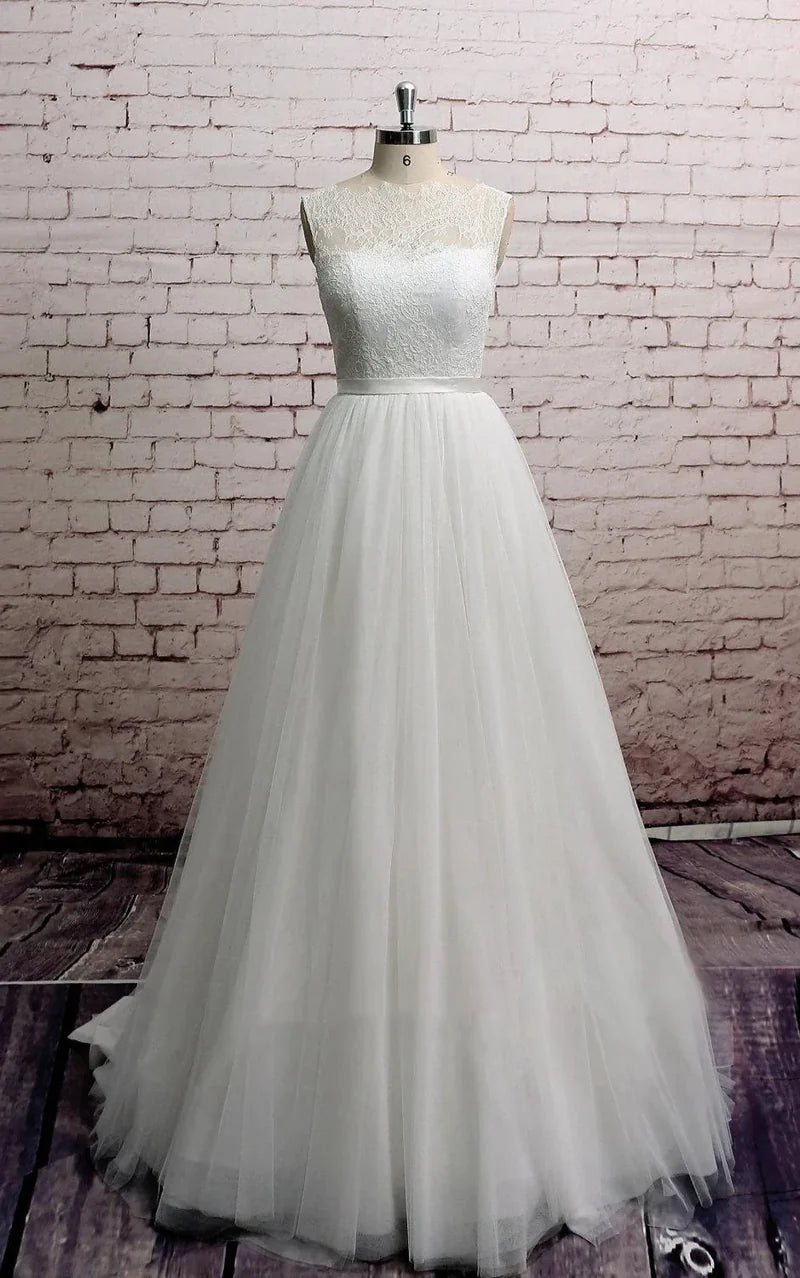 A-line wedding dress with a delicate tulle neckline and flowing skirt.