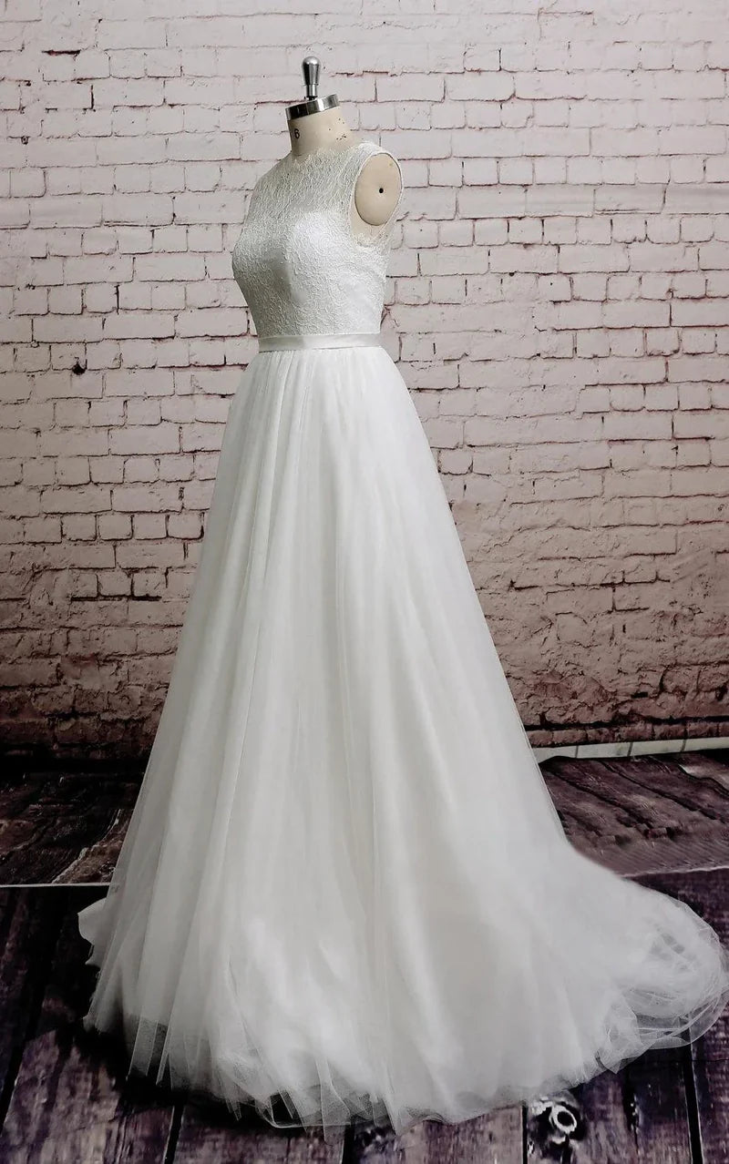 Side profile of a romantic A-line wedding dress, highlighting the tulle detail.