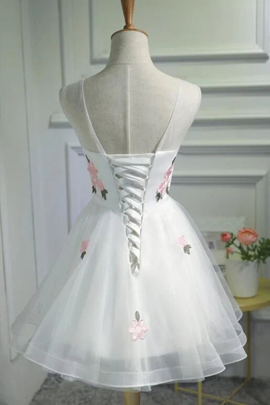 Sleeveless A-line graduation dress with pink floral appliques.