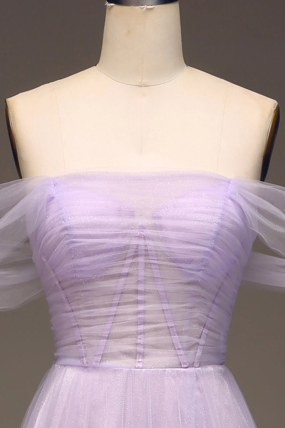 Close-up of the bodice and delicate tulle fabric of the lilac prom dress.