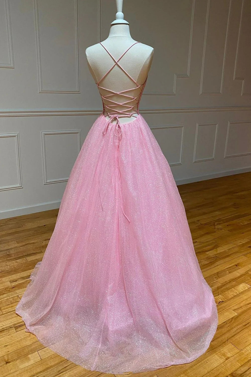Back view of an elegant A-Line tulle prom dress, highlighting the backless design.