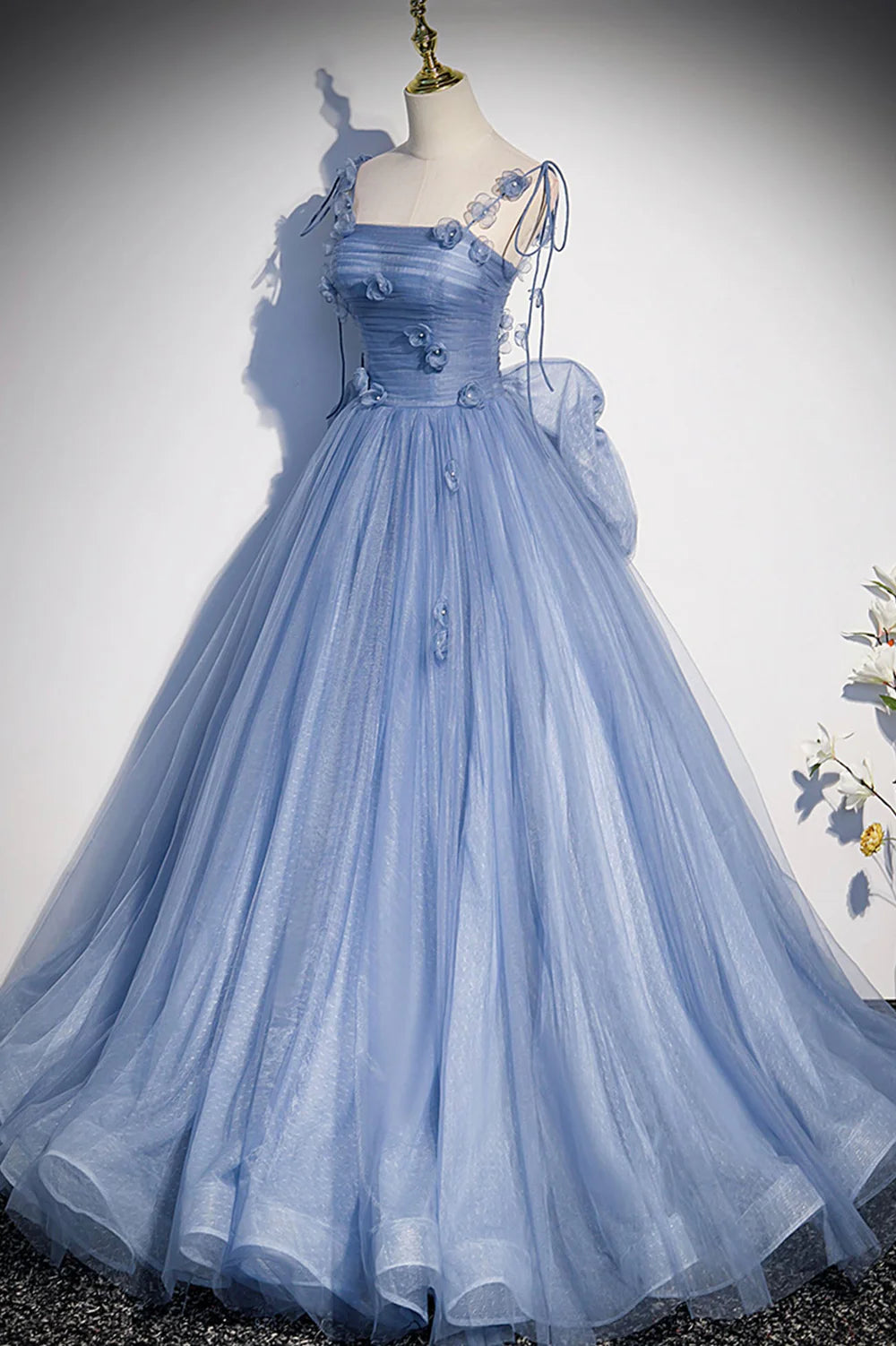Side profile of a woman in the long A-line tulle formal dress.
