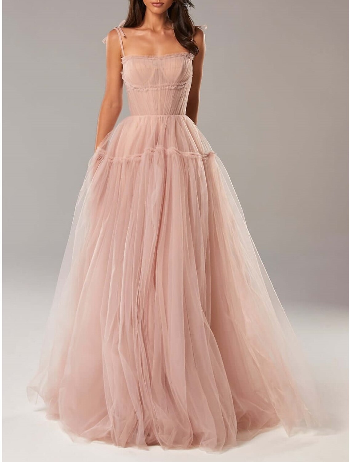 Close-up of the pleated bodice and spaghetti strap on the dress.