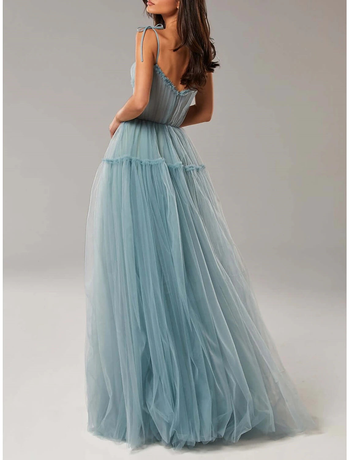 Detail of the ruffled hem and tulle fabric of the elegant gown.