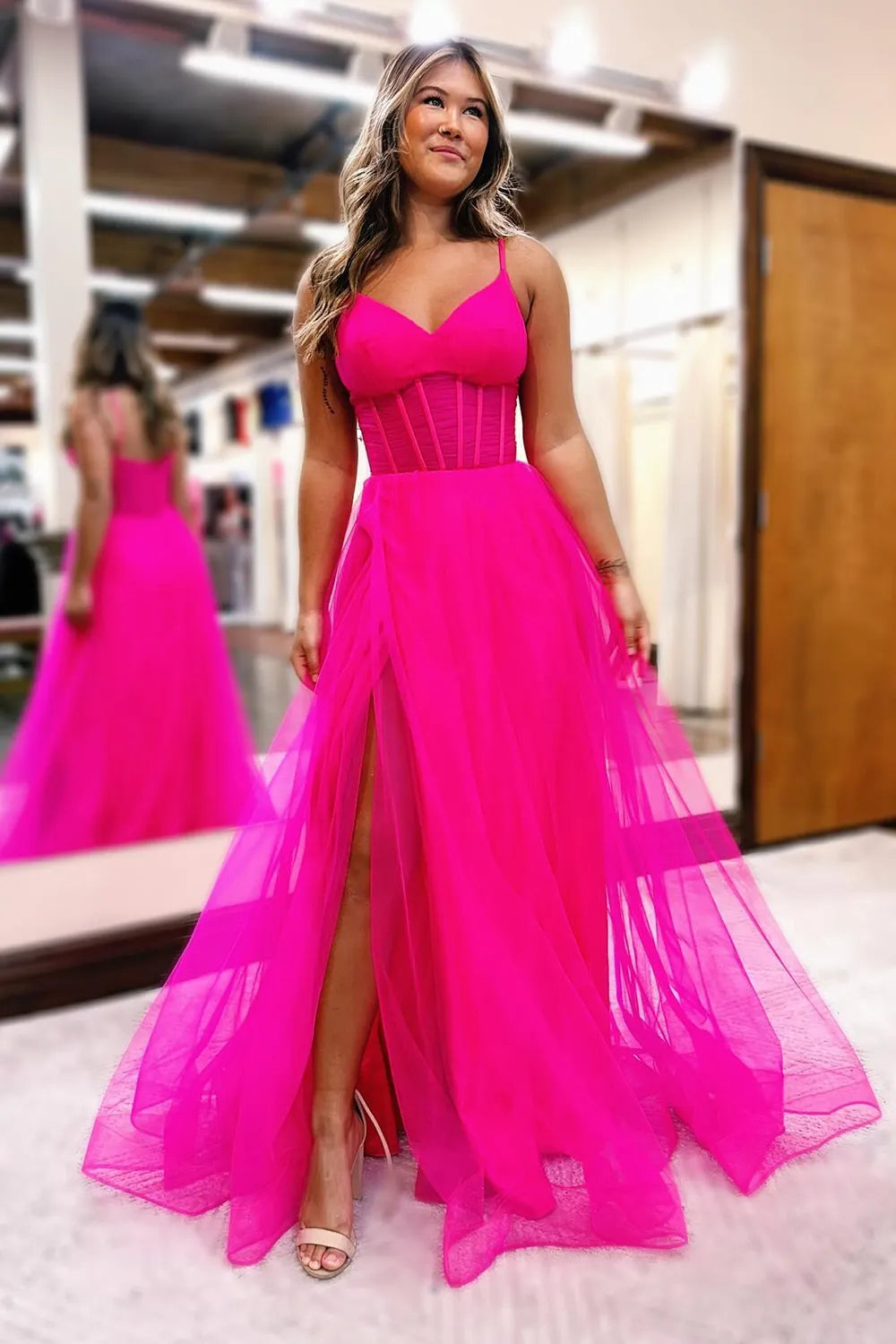 Elegant A-line tulle prom dress with spaghetti straps and a side slit.