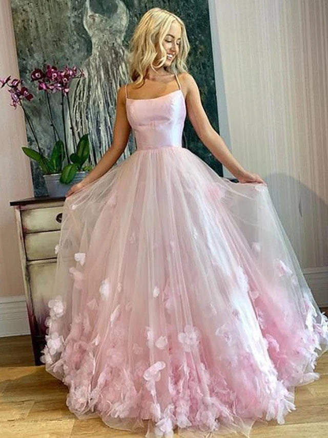 Elegant A-line tulle prom dress with spaghetti straps and appliques.
