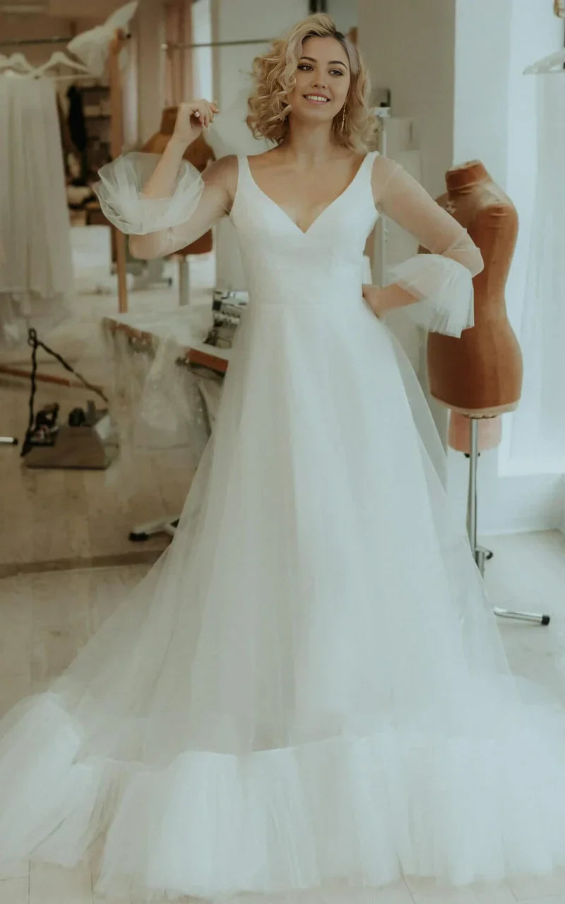 Elegant A-Line Tulle V-Neck wedding dress with ruching, front view on model.