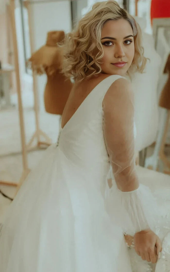 Close-up of the soft tulle fabric and intricate ruching on the wedding dress.