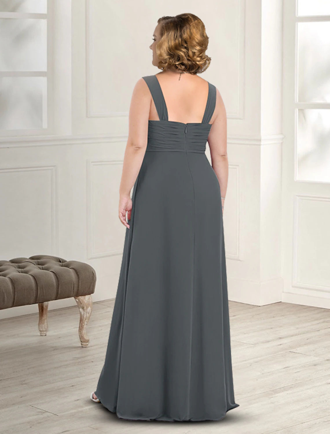 Close-up of the square neckline and pleated detail on the elegant chiffon dress.