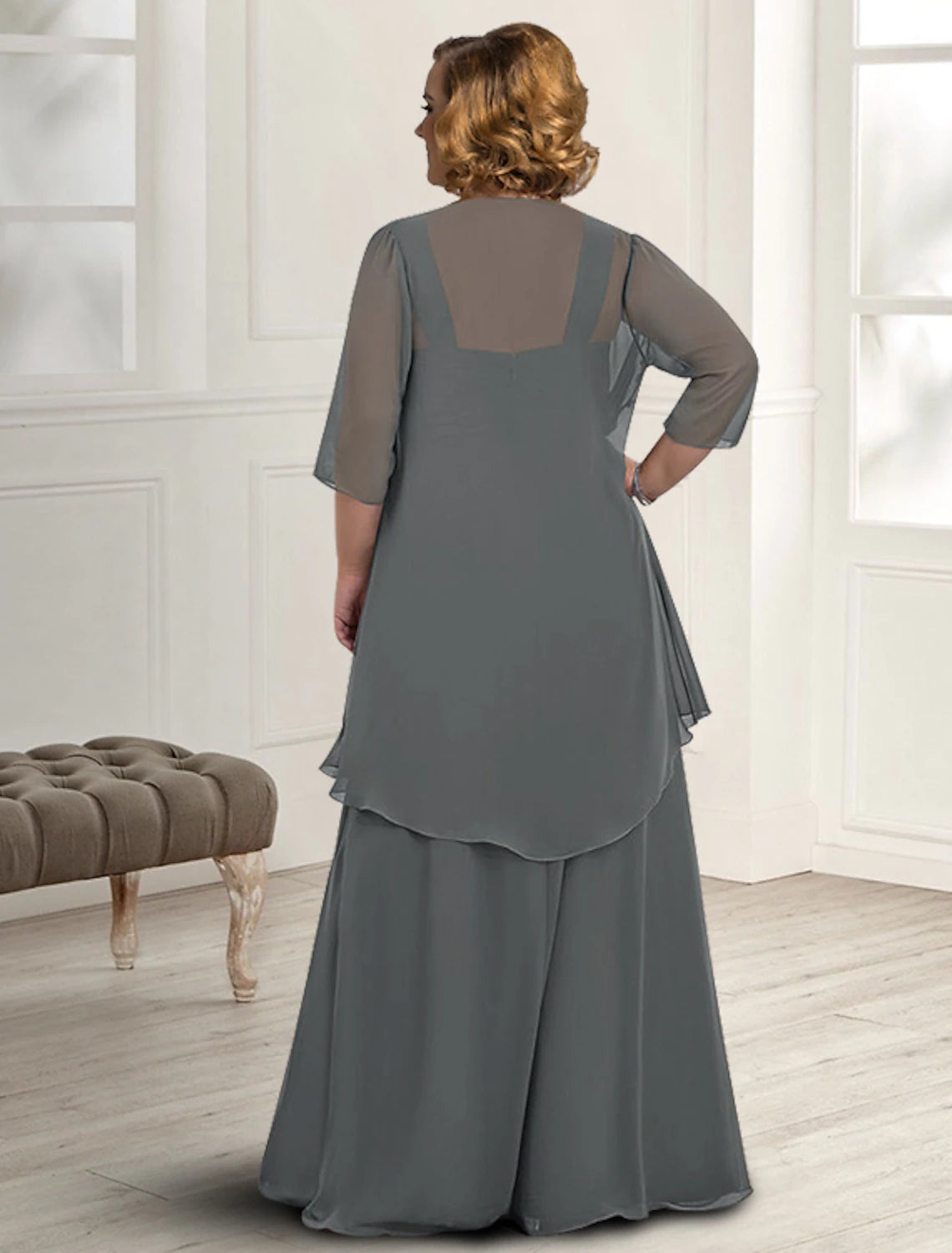 Side view of the woman in the two-piece A-line Mother of the Bride dress, highlighting the silhouette.