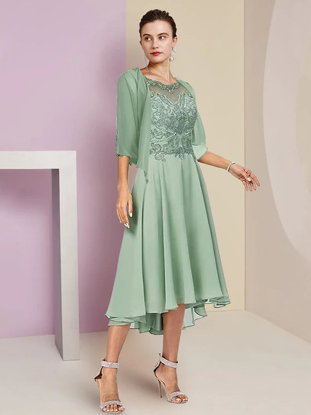 Woman wearing an elegant slate blue two-piece A-line mother of the bride dress with lace top and high-low chiffon skirt.
